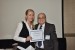 Dr. Nagib Callaos, General Chair, giving Mrs. Zuzana Loncova the best paper award certificate of the session "ICT Applications in Health Care and Bio-Medical ICT II." The title of the awarded paper is "Interdisciplinary Research in Field of Biomedical Image Processing."